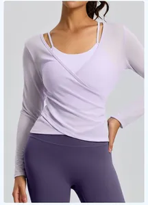 Detailed macro view of light purple mesh long-sleeve yoga top featuring wrap-front design