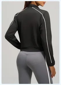 Rear view of black women's sports jacket with contrast white piping and stand collar