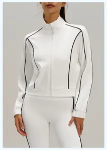 Detailed close-up of a white fitness jacket with black contrast piping and zipper