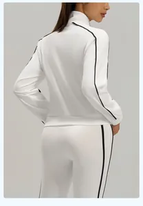 Detailed back view of a white sporty tracksuit jacket and pants with black contrast stripes