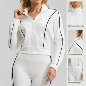 Professional women's white cropped sports jacket with contrast black piping and stand collar
