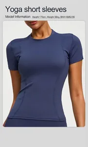 Detailed view of a navy blue athletic yoga short sleeve top worn by a professional model