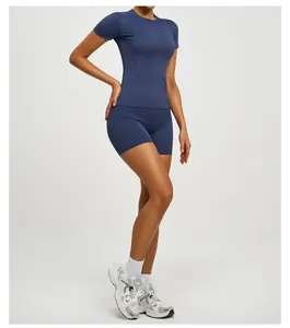 Macro view of women's blue slim-fit yoga set featuring short-sleeve top and shorts
