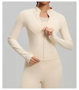 Close-up of a slim fit yoga jacket in beige featuring zip-up design and thumb holes