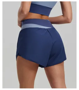 Detail view of women's high-waist color-block yoga shorts in navy and light blue.