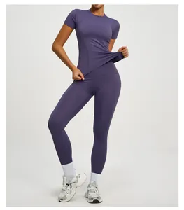 Detail of purple athletic set featuring slim-fit short sleeve top and high-waist leggings
