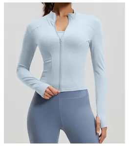 Slim-fit women's light blue yoga zip-up jacket with thumb holes for gym and running