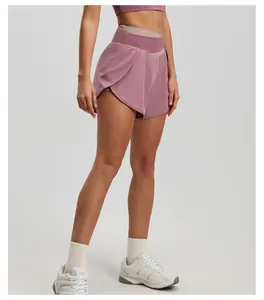 Detailed side view of mauve high-waisted yoga shorts with contrasting waistband shown on model