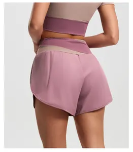 Back view close-up of breathable color-block high-waisted yoga shorts in purple and tan