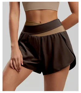 Close-up of high-waisted color-block yoga shorts with a criss-cross waistband design