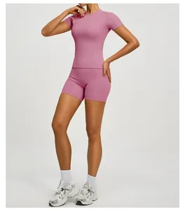 Slim fit pink yoga set featuring a short sleeve sport top and high-waist biker shorts