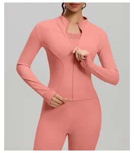 Close-up of a slim-fit peach long-sleeved yoga jacket with a functional zipper detail.