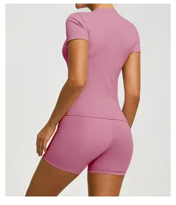Detailed back view of dusty pink short-sleeved athletic top and tight yoga shorts set