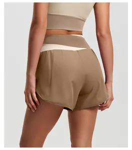 Detail shot of the back of high-waist color-block yoga shorts in khaki and beige tones