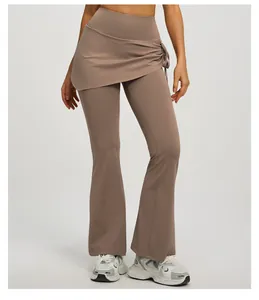 Close-up detail of the ruched skirt overlay on high-waisted mauve flared yoga leggings