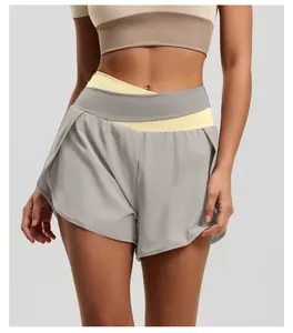 Close-up detail of high-waist color-block yoga shorts in grey and yellow
