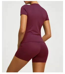 Detail back view of burgundy short sleeve yoga top and tight shorts set for women