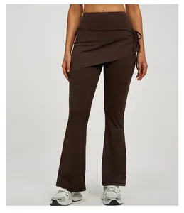 Close-up of brown high-waist flared yoga pants with ruched mock skirt detail
