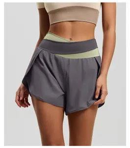 Close-up detail of high-waisted color-block yoga shorts with crossover waistband