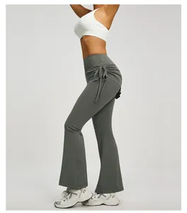 A professional side view of grey high waisted flared yoga pants featuring ruched drawstring details