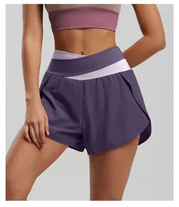 Detailed view of high-waisted yoga shorts featuring a crossover color-block waistband