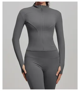 Close-up of a dark grey slim-fit sports jacket with zipper and thumbholes for yoga.