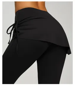Close-up detail of the adjustable side drawstring and ruched skirt on black yoga leggings