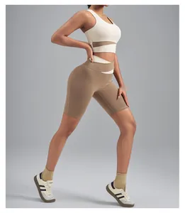 Two-piece yoga set with high-waisted biker shorts and sports bra in khaki and cream