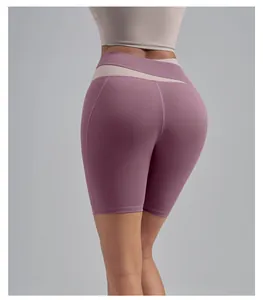 Back view detail of high-waisted mauve yoga shorts featuring a peach lift design and crossover waist.