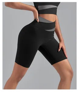 Close-up detail of high-waisted color-block yoga shorts with peach lifting design