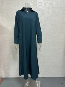 Detailed view of an elegant teal long-sleeve V-neck maxi dress for women on mannequin