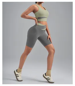 Two-piece green and grey yoga set with high-waisted biker shorts and sports bra