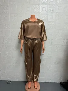 Full view of women's two-piece bronze satin outfit with cargo pants on mannequin
