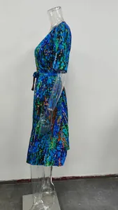 Detailed side view of a vibrant blue abstract floral print V-neck dress on clear mannequin