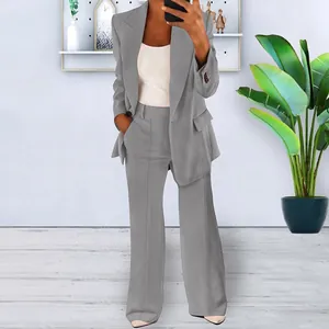 Full body detail of a women's professional grey two-piece blazer and trousers suit set