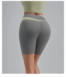 Back view detail of high-waisted yoga biker shorts with peach-lift design and contrast waist