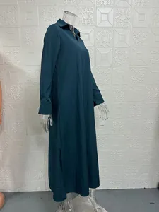Close-up of a loose fit dark green V-neck long sleeve maxi dress on a mannequin.