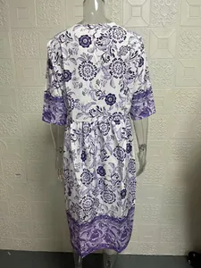 Detailed back view of an elegant purple floral print maxi dress on a studio mannequin