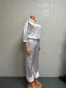 Side view of white satin two-piece outfit featuring half sleeve top and cargo pants