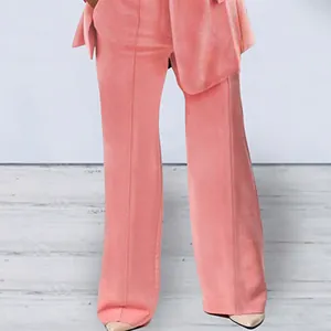 Close-up detail of women's trendy coral pink wide-leg trousers from a stylish two-piece suit set