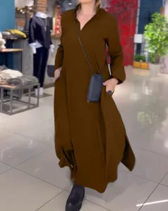 Close-up of brown loose V-neck maxi dress with long sleeves and pocket details