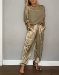 Elegant champagne gold satin two-piece set featuring short sleeve top and cargo pants.