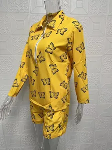 Detail of yellow butterfly print set showing long-sleeve zipper top and matching shorts