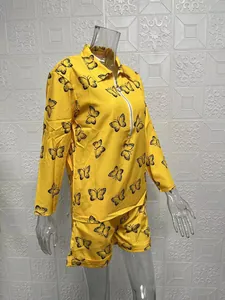 Yellow butterfly print two-piece set with long sleeve zip top and shorts on mannequin