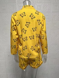 Back view of yellow butterfly print women's two-piece set with long sleeves and shorts