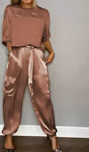 Elegant dusty rose satin two-piece set featuring short-sleeve top and cargo pants