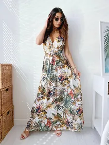 Full-length view of a tropical floral print V-neck maxi dress with tie-waist detail.