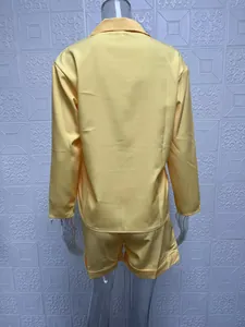 Back view of a bright yellow two-piece set with a long-sleeved shirt and matching shorts