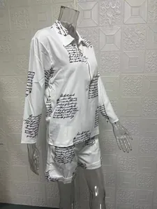 Close-up of a white two-piece set featuring script print shirt and matching shorts