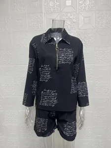 Stylish women's black two-piece set with long sleeve zip top and printed shorts
